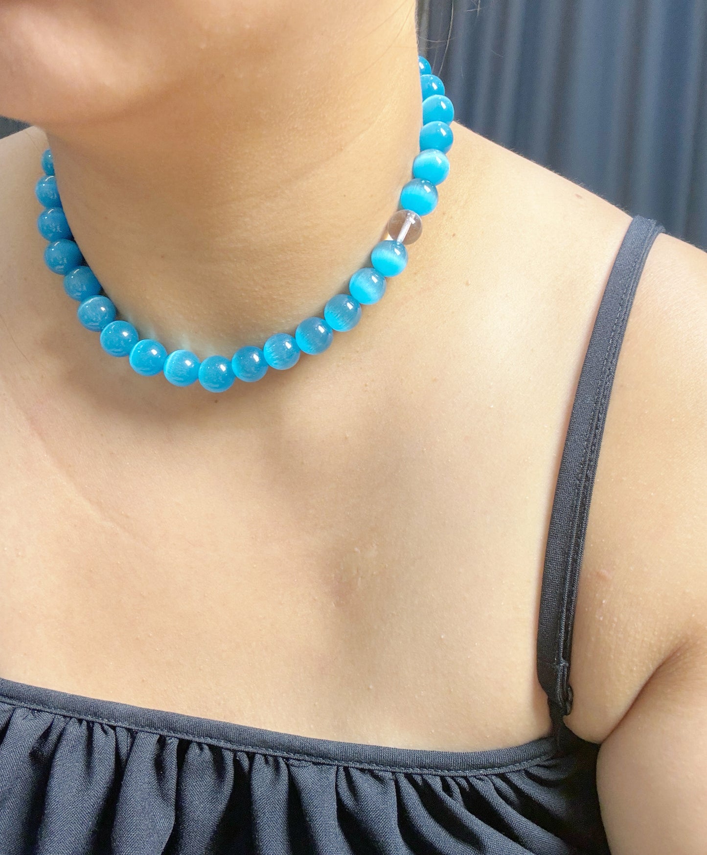 sweet necklace with dark blue cat's eye and white crystal